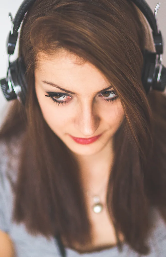 A female patient takes a hearing test using over the ear headphones